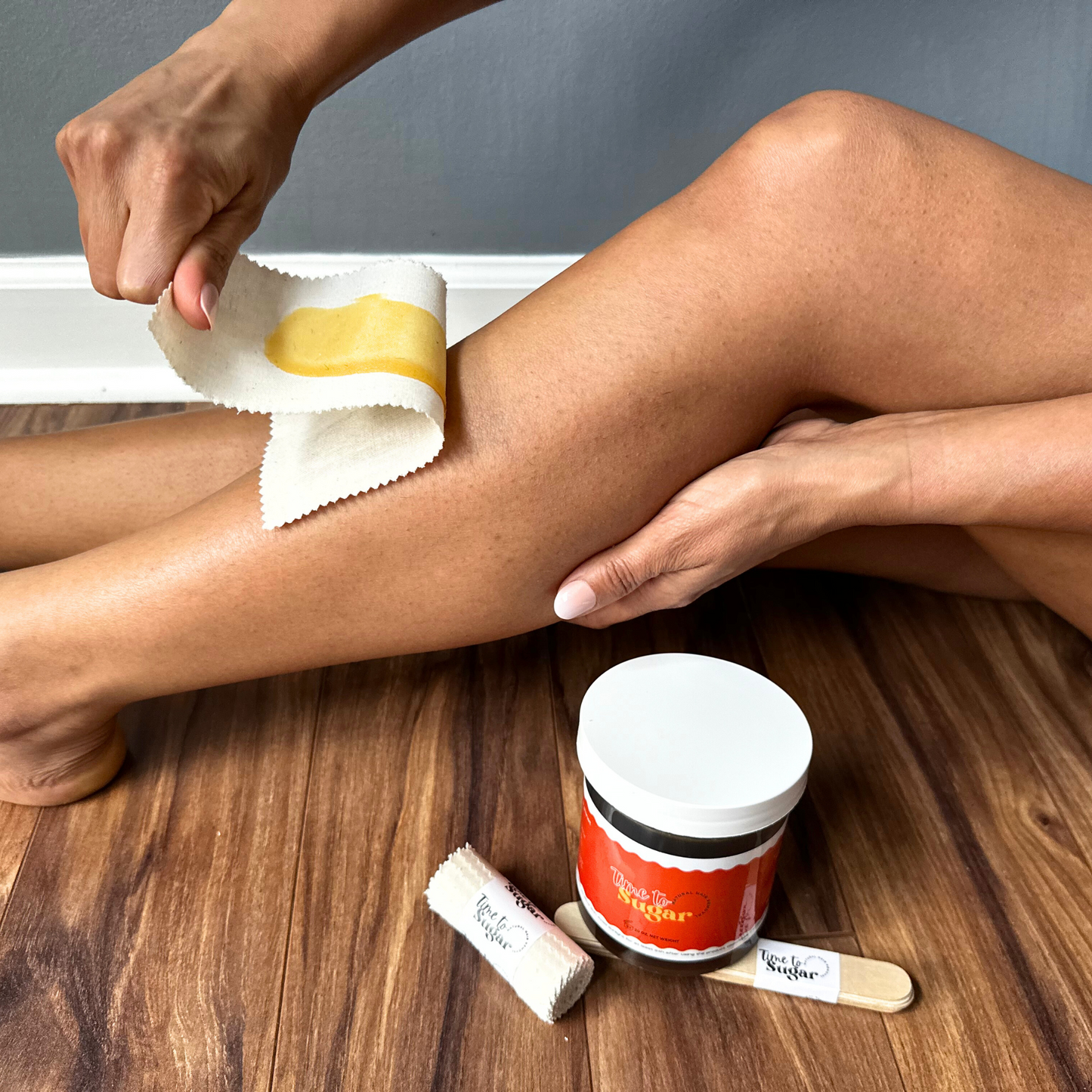 Removal of strip and sugaring paste from legs for natural hair removal with Time To Sugar