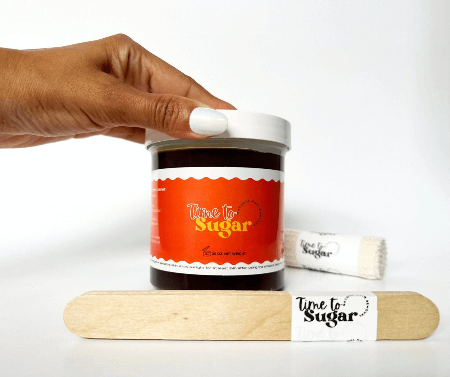 Jar of sugar wax by Tie To Sugar with strips and spatulas