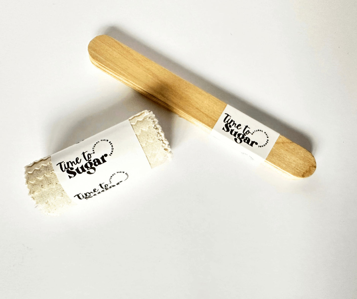 Reusable cotton strips and wooden spatulas with Time To Sugar logo